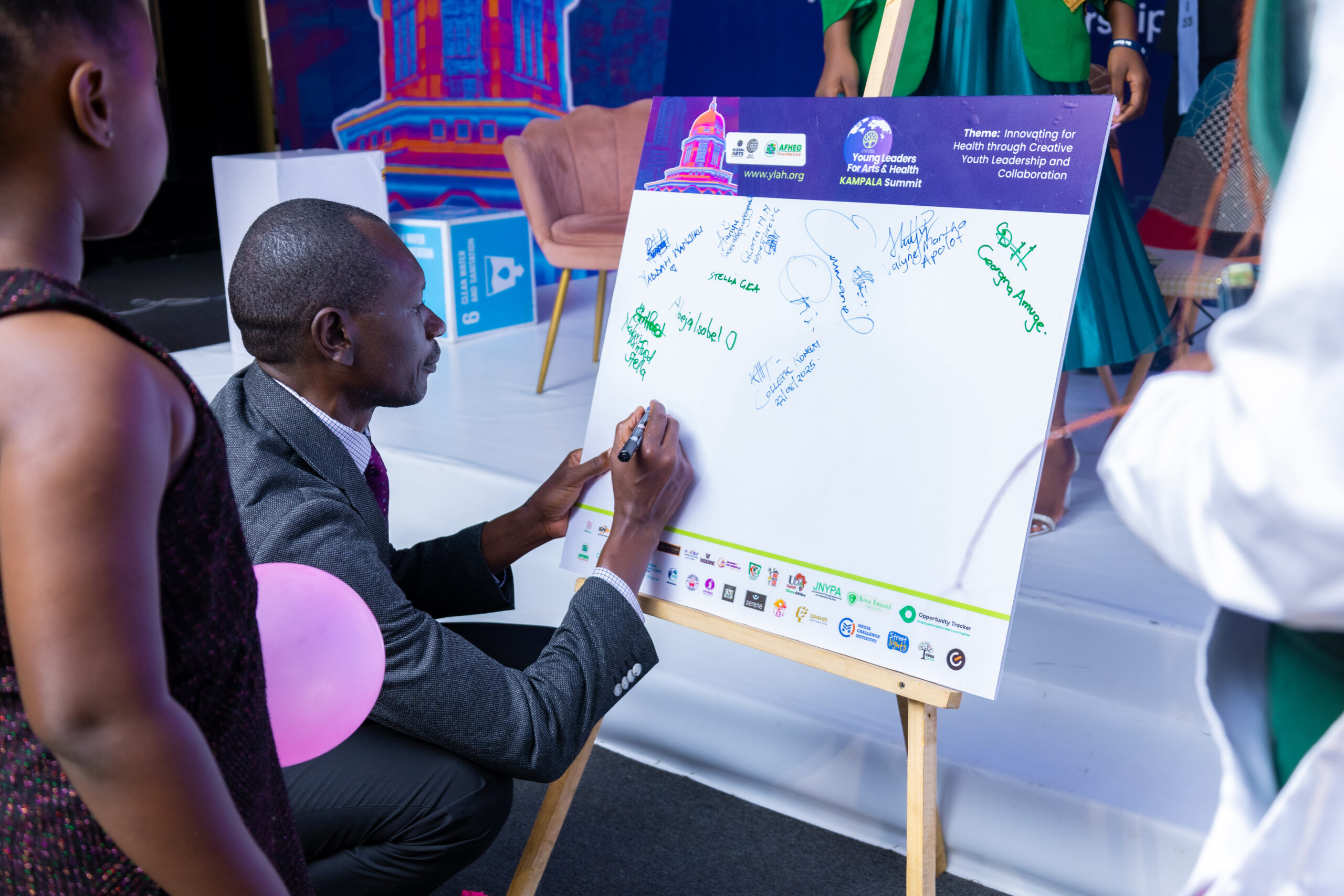 Participant contributing to a creative activity at the Young Leaders for Arts and Health Kampala Summit